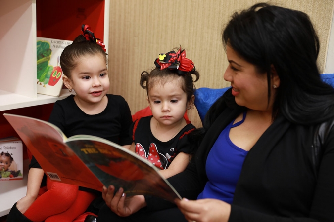 Woman reads to two girls