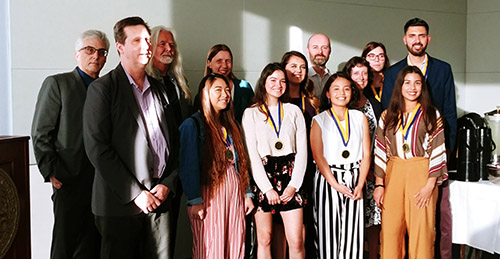 Students and faculty members pose for a photo at the Outstanding Student Awards reception for the School of Social Sciences, Humanities and Arts.