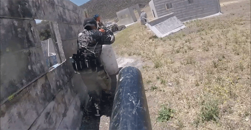 Action shot of participant in paintball battle