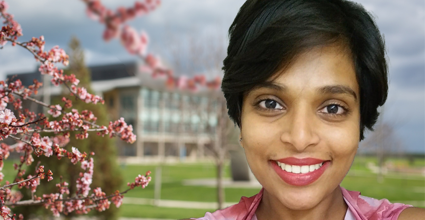 Ritwika Vallomparambath PanikkasserySugasree next to cherry blossoms