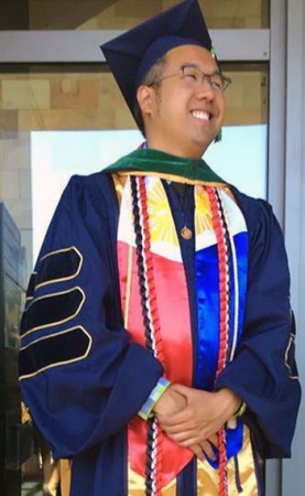 Dr. Randell Rueda decorated in academic regalia