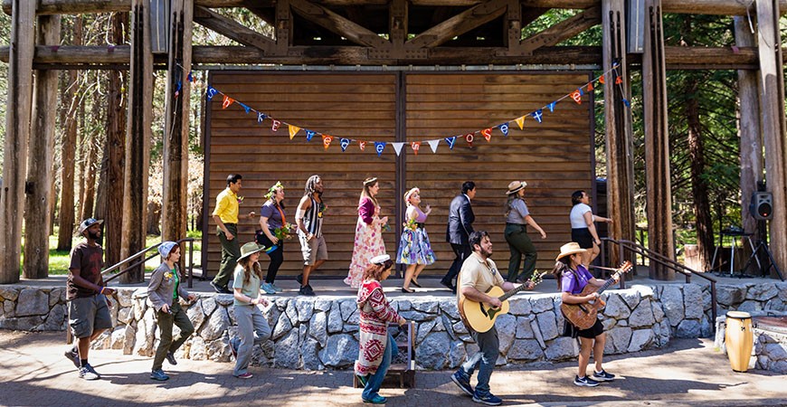 Cast performing a sing-along from "As You Like It"