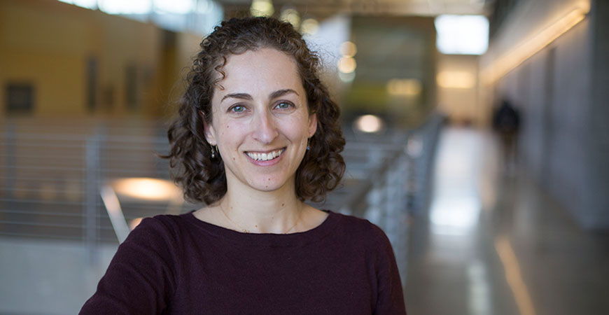 Professor Goldman-Mellor poses in a campus hallway