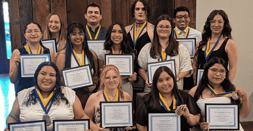 Thirteen recipients for the Outstanding Graduating Student Award pose for a group photo.