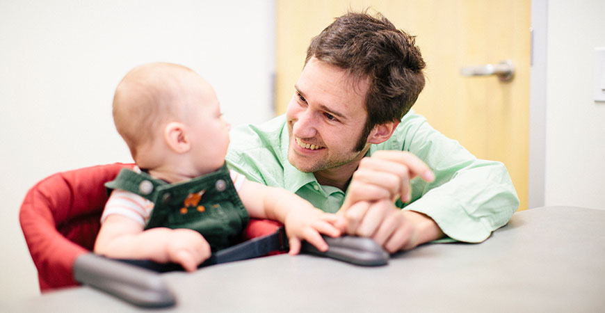 Professor Eric Walle with a baby
