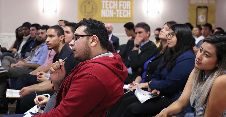 Audience members listen to UC Merced alumni talk about their post-graduation careers