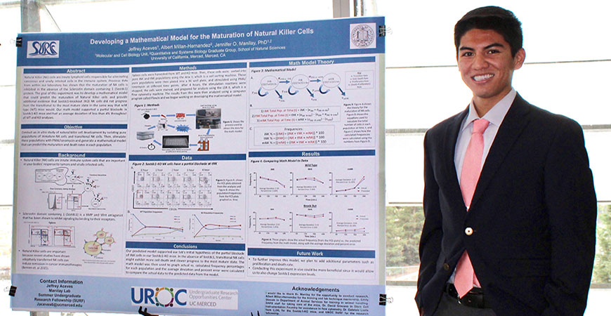 Jeffrey Aceves stands next to research poster on natural killer cells