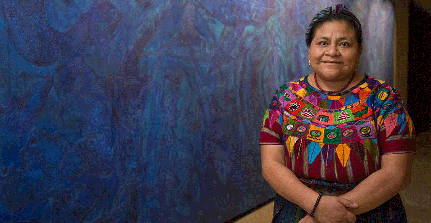 Rigoberta Menchú Tum posing in front of a blue wall