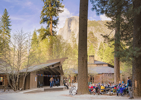 A stage performance at the Lower River Amphitheatre featuring Yosemite views