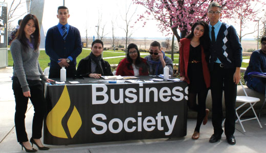 Students posing around UC Merced Business Society booth