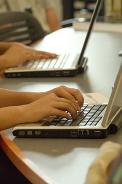 Students typing on computer